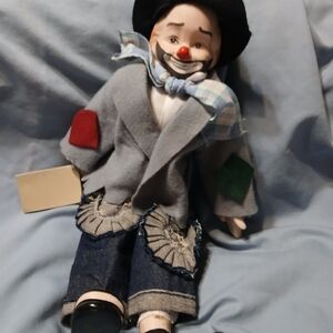 Vintage NWT porcelain hobo clown doll. It's  musical and it does work.